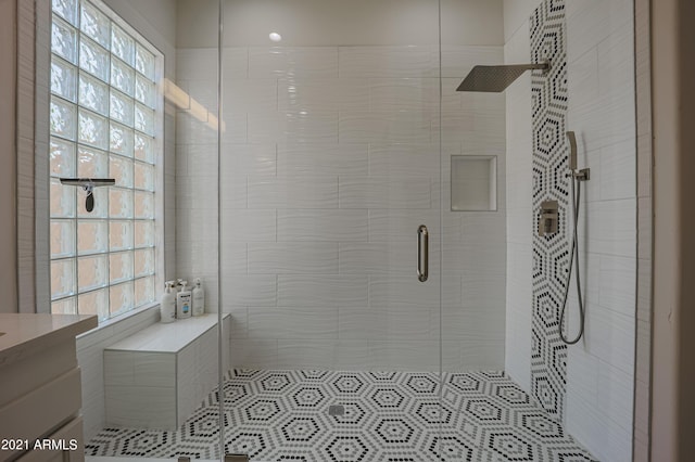 bathroom featuring walk in shower, a healthy amount of sunlight, and vanity