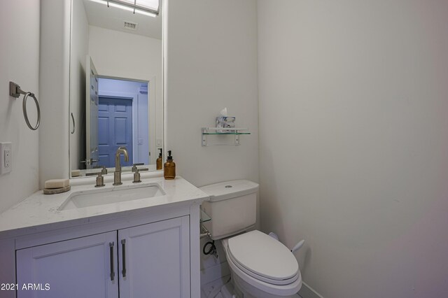 bathroom with toilet and vanity