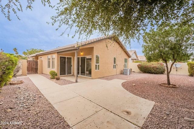 rear view of house featuring a patio area and central air condition unit