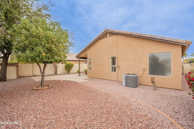 back of house featuring a patio area and central air condition unit