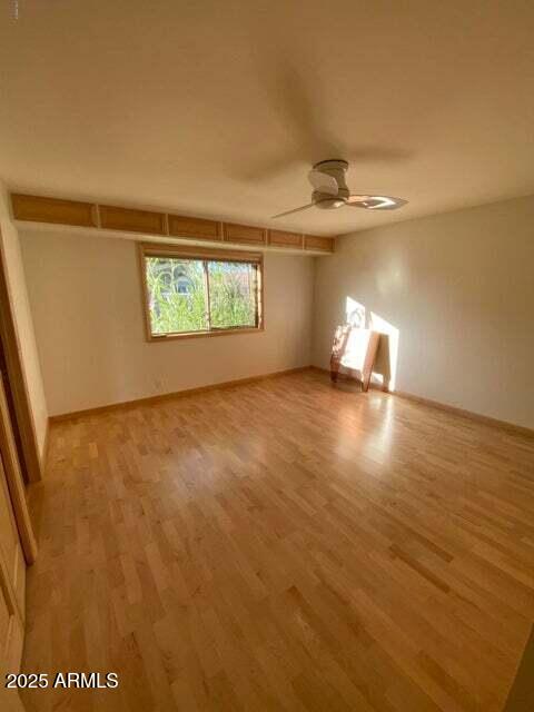 unfurnished room featuring ceiling fan and light wood-style flooring