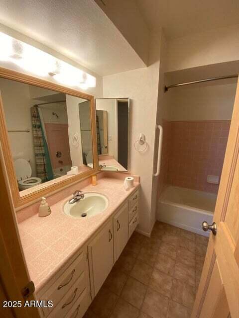 full bath with vanity, shower / bath combination with curtain, and tile patterned floors