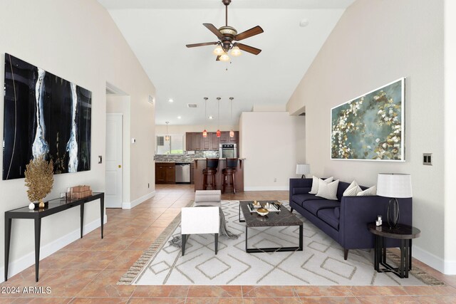 living room with high vaulted ceiling, ceiling fan, and light tile patterned floors