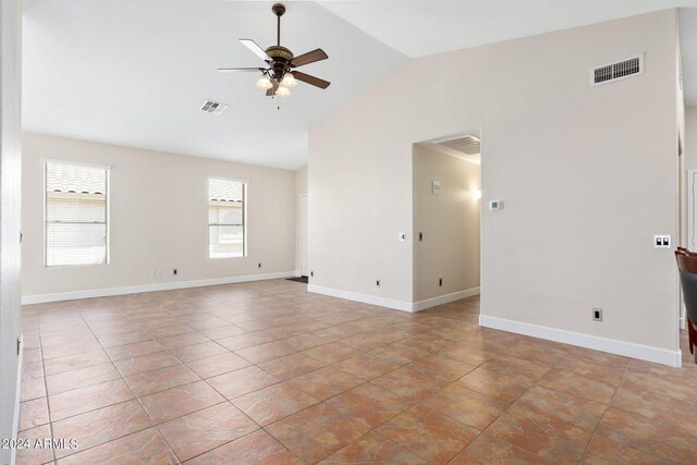 unfurnished room with light tile patterned floors, vaulted ceiling, and ceiling fan