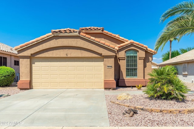 mediterranean / spanish-style house with a garage