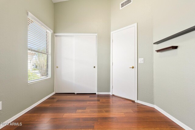 unfurnished bedroom featuring dark wood-type flooring