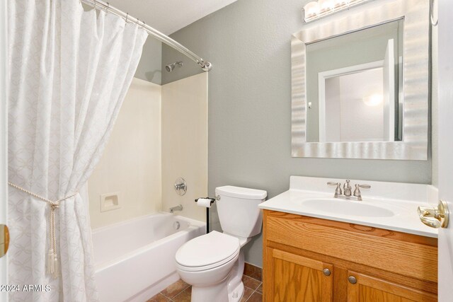 full bathroom with shower / bath combo with shower curtain, tile patterned flooring, vanity, and toilet