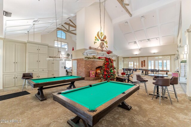 recreation room featuring high vaulted ceiling, a brick fireplace, pool table, and light carpet