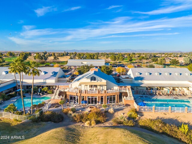 rear view of property with a community pool and a patio area