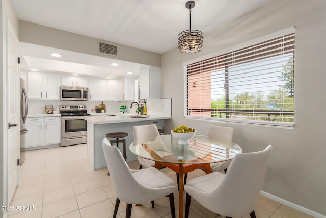 12222 N Paradise Village Pkwy S Unit 237, Phoenix, AZ 85032 - dining room featuring light tile patterned floors, baseboards, and recessed lighting