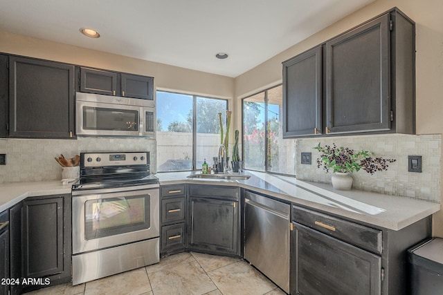 kitchen with sink, stainless steel appliances, and tasteful backsplash