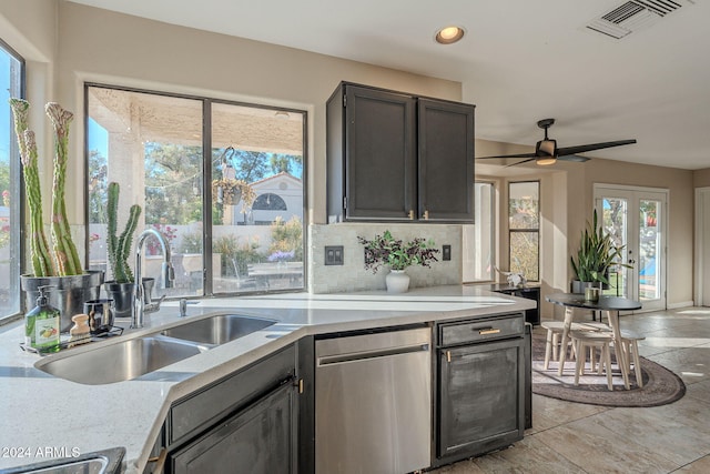 kitchen featuring decorative backsplash, dishwasher, ceiling fan, and sink