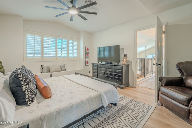 bedroom with ceiling fan, light hardwood / wood-style floors, and vaulted ceiling