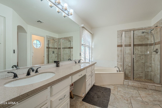 bathroom featuring a wealth of natural light, vanity, and shower with separate bathtub