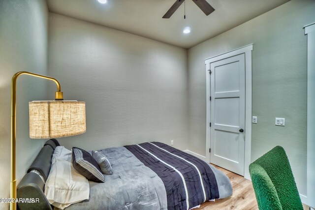 bedroom with light hardwood / wood-style flooring and ceiling fan