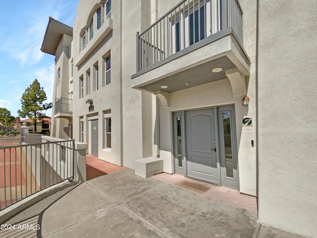 entrance to property with a balcony