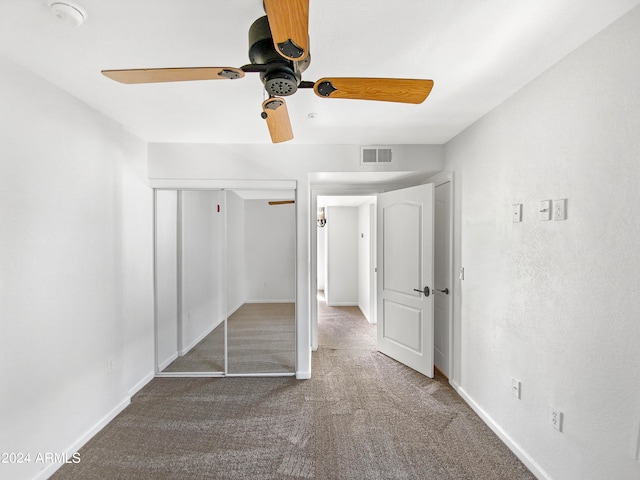 unfurnished bedroom with carpet floors, ceiling fan, and a closet