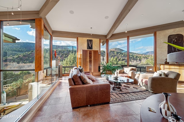 tiled living room with beam ceiling, a mountain view, and a wealth of natural light