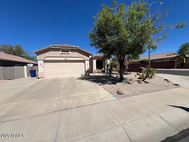 10064 E Kilarea Ave, Mesa, AZ 85209 - view of front facade featuring stucco siding, concrete driveway, and a garage