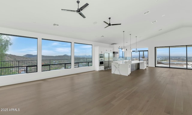 301 E Jomax Rd, Phoenix, AZ 85085 - unfurnished living room with ceiling fan, lofted ceiling, dark wood-style flooring, a mountain view, and a sink