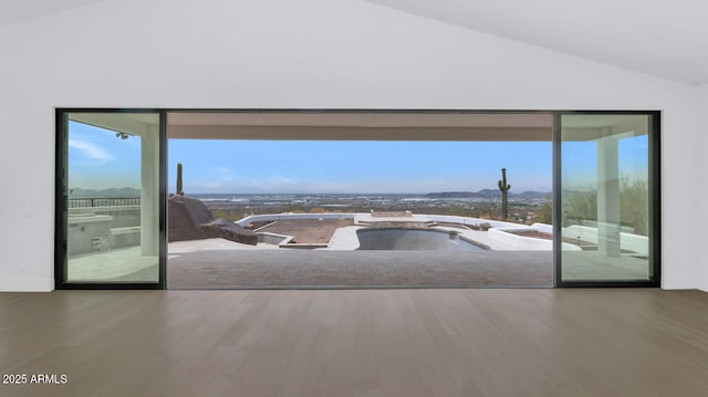 301 E Jomax Rd, Phoenix, AZ 85085 - empty room with lofted ceiling, wood finished floors, a mountain view, and baseboards