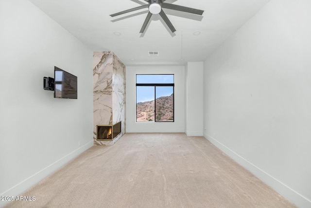 301 E Jomax Rd, Phoenix, AZ 85085 - unfurnished living room featuring carpet floors, a premium fireplace, ceiling fan, and baseboards