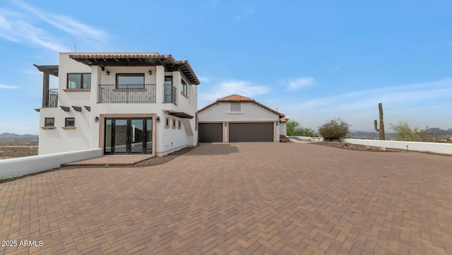 301 E Jomax Rd, Phoenix, AZ 85085 - view of front of home featuring a balcony, decorative driveway, stucco siding, and a garage