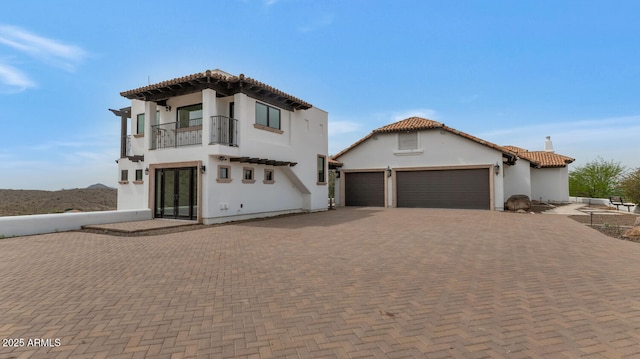 301 E Jomax Rd, Phoenix, AZ 85085 - mediterranean / spanish house with a balcony, decorative driveway, an attached garage, stucco siding, and a tiled roof