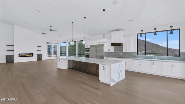 301 E Jomax Rd, Phoenix, AZ 85085 - kitchen featuring stainless steel appliances, a ceiling fan, wood finished floors, tasteful backsplash, and a large island
