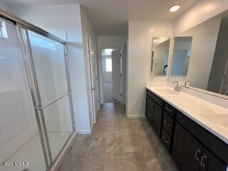 bathroom with vanity and a shower with shower door