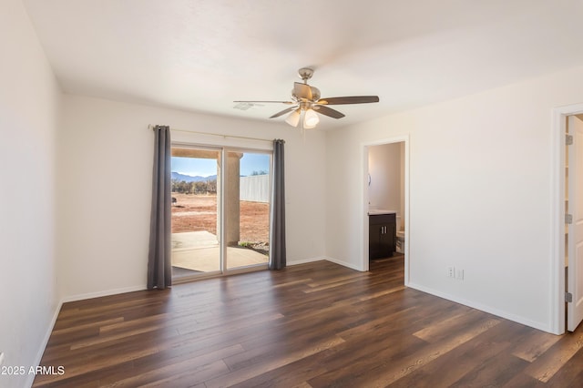 spare room with ceiling fan and dark wood-type flooring