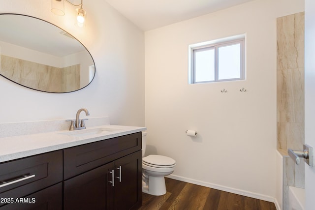 bathroom featuring wood-type flooring, toilet, and vanity