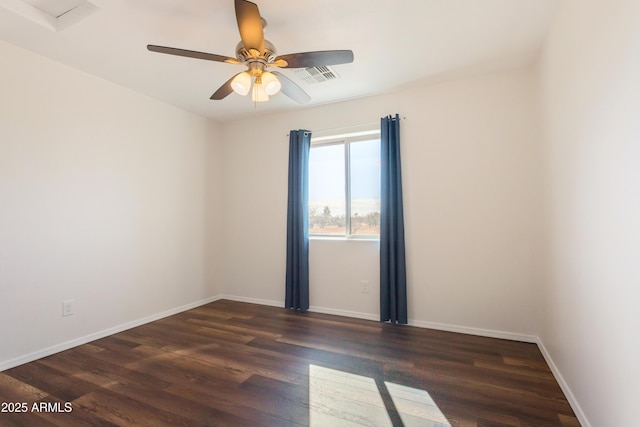 spare room with ceiling fan and dark hardwood / wood-style floors