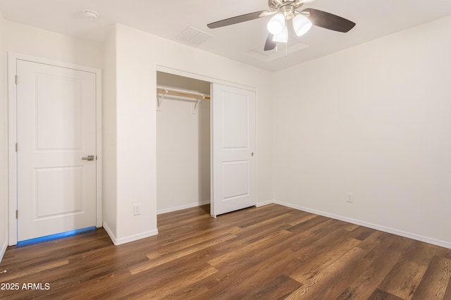 unfurnished bedroom with ceiling fan, dark hardwood / wood-style floors, and a closet