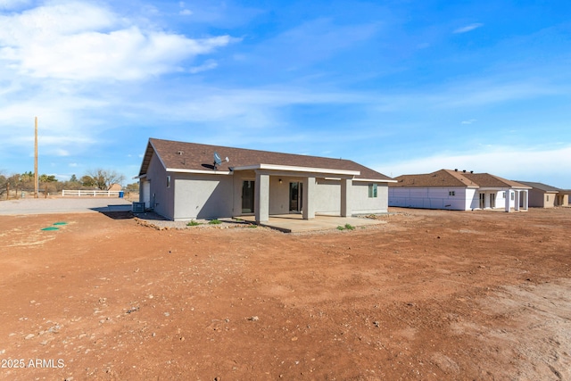 rear view of property featuring a patio