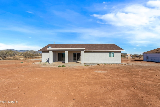 rear view of property with a patio area and a mountain view