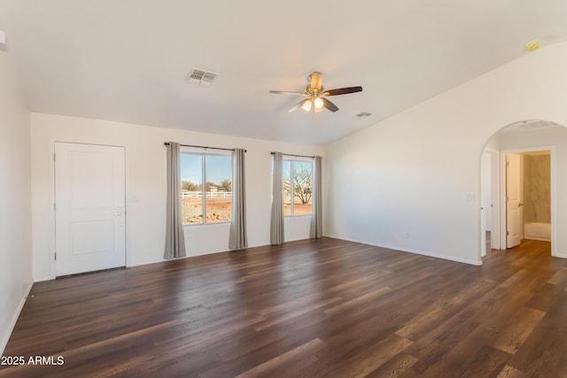 empty room featuring ceiling fan, dark wood-type flooring, and lofted ceiling