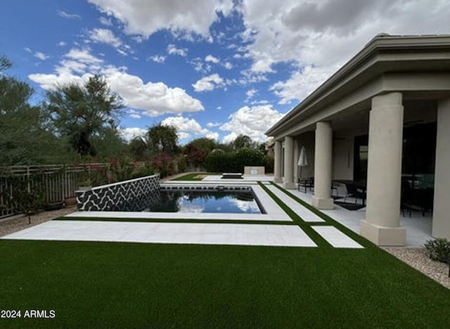 view of pool with a fenced in pool, a patio area, fence, and a lawn