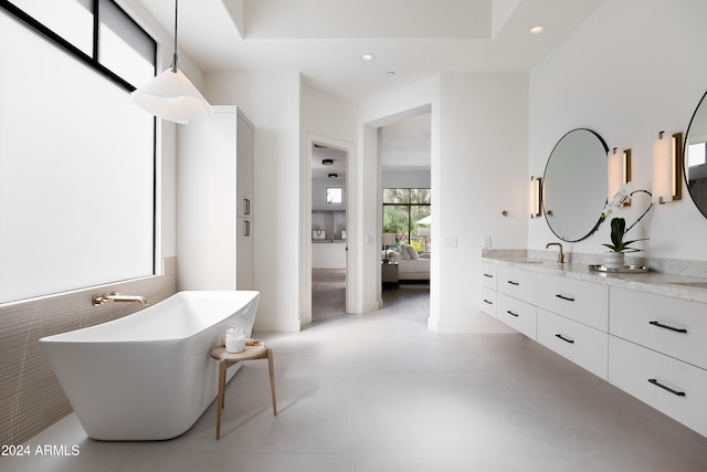 full bath featuring a soaking tub, ensuite bath, vanity, and recessed lighting