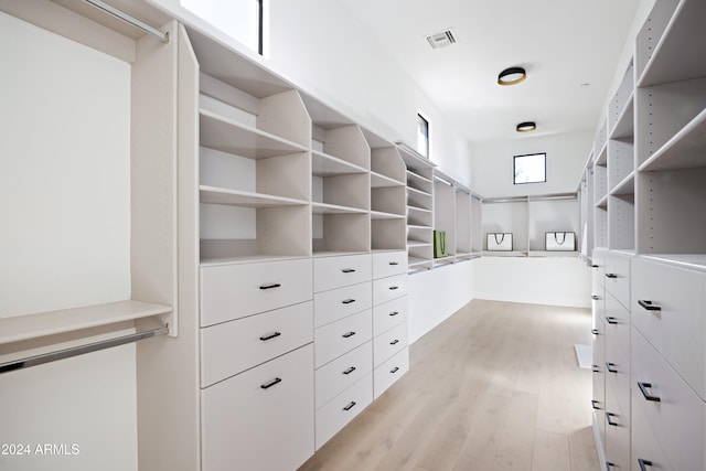 walk in closet featuring light wood-type flooring and visible vents