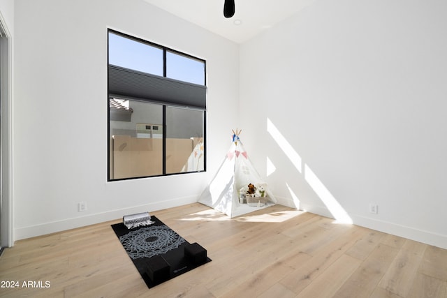 spare room with baseboards and light wood-style floors