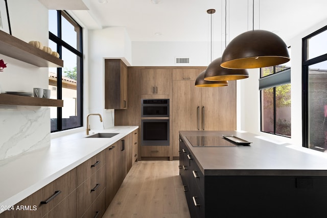 kitchen with hanging light fixtures, black electric cooktop, visible vents, and open shelves