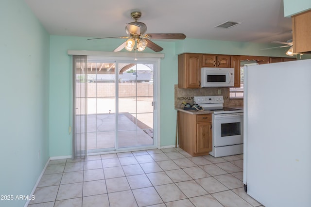 3098 N Starlight Dr, Prescott Valley, AZ 86314 - kitchen with white appliances, a ceiling fan, decorative backsplash, and baseboards