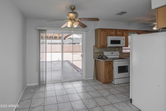 3098 N Starlight Dr, Prescott Valley, AZ 86314 - kitchen featuring white appliances, a ceiling fan, healthy amount of natural light, and backsplash