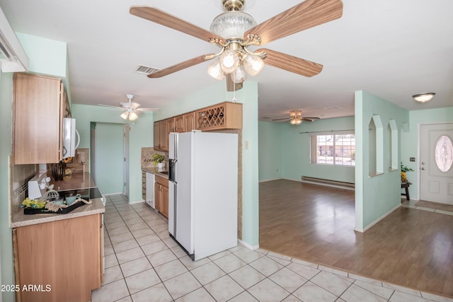 3098 N Starlight Dr, Prescott Valley, AZ 86314 - kitchen featuring white appliances, a baseboard heating unit, ceiling fan, and light tile patterned floors