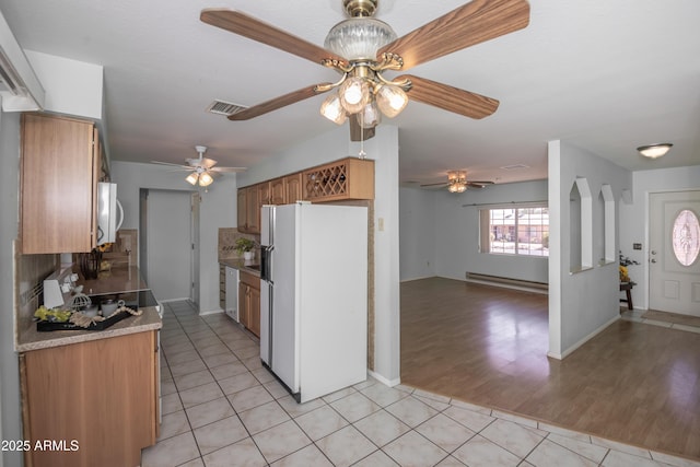 3098 N Starlight Dr, Prescott Valley, AZ 86314 - kitchen featuring white appliances, baseboard heating, a ceiling fan, and light tile patterned floors