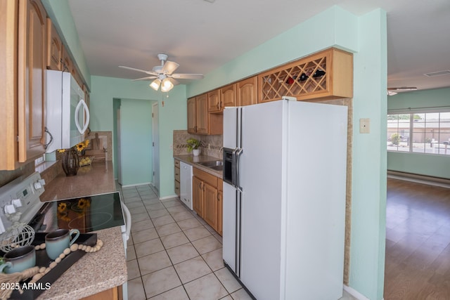 3098 N Starlight Dr, Prescott Valley, AZ 86314 - kitchen featuring white appliances, a ceiling fan, backsplash, light countertops, and light tile patterned flooring