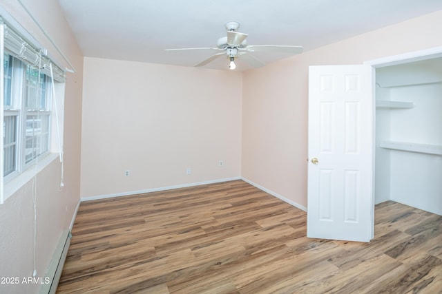 3098 N Starlight Dr, Prescott Valley, AZ 86314 - unfurnished bedroom featuring wood finished floors, baseboards, and ceiling fan
