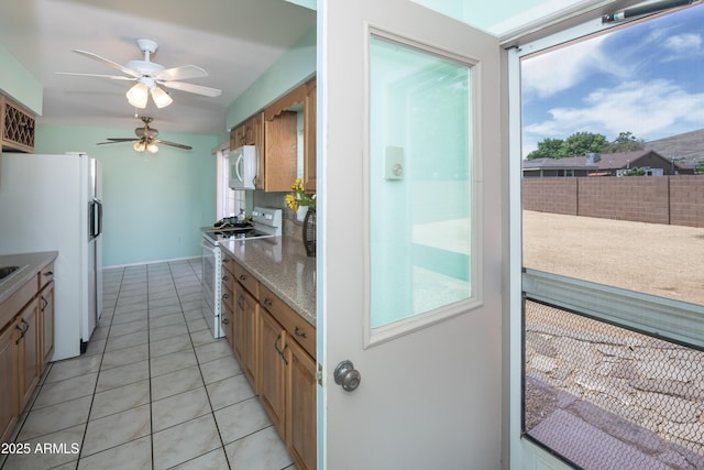 3098 N Starlight Dr, Prescott Valley, AZ 86314 - kitchen featuring white appliances, ceiling fan, plenty of natural light, and light tile patterned flooring