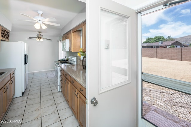 3098 N Starlight Dr, Prescott Valley, AZ 86314 - kitchen featuring white appliances, ceiling fan, plenty of natural light, and light tile patterned floors